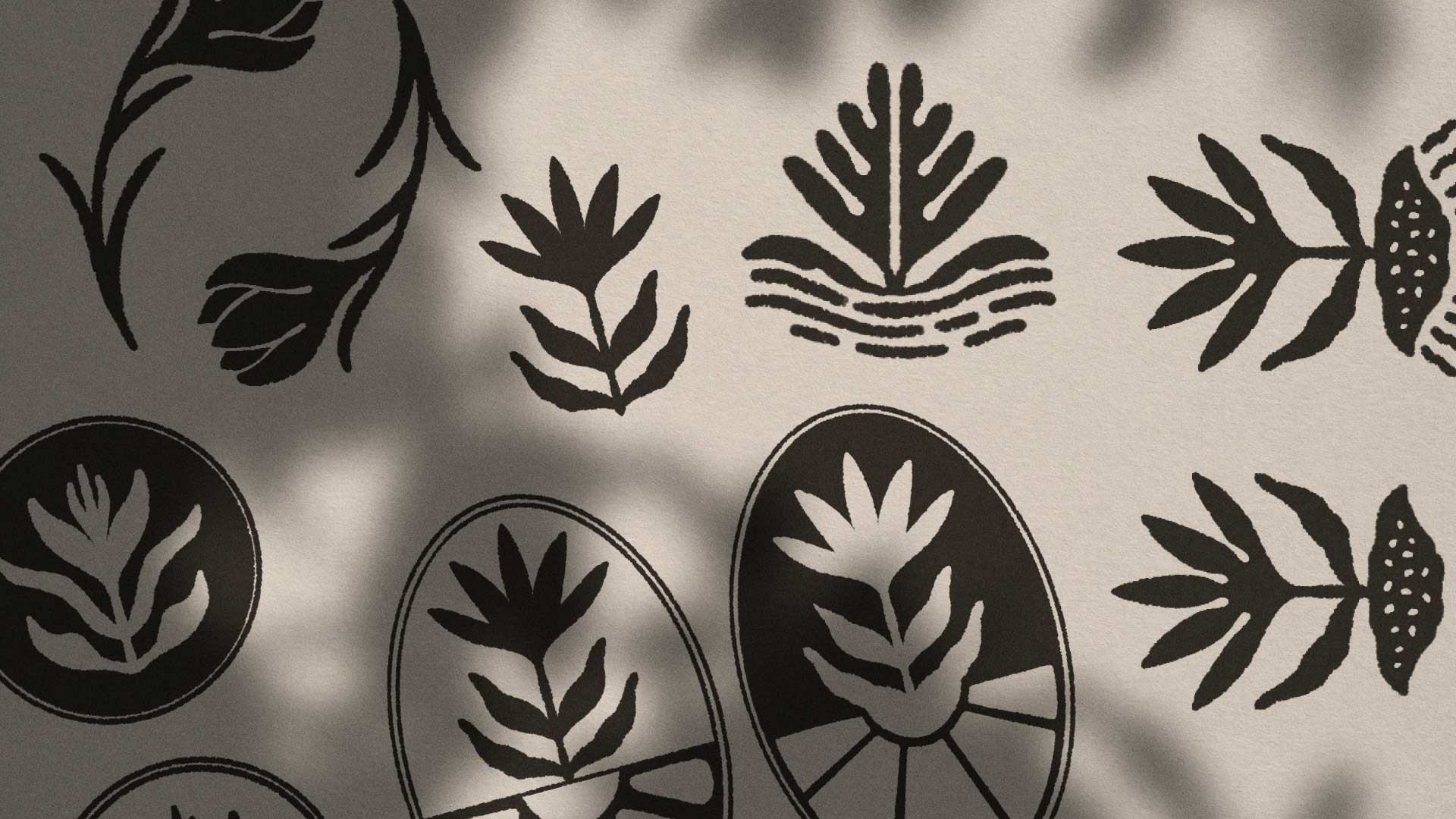 Stamp logo iterations on a white paper with organic shadows above