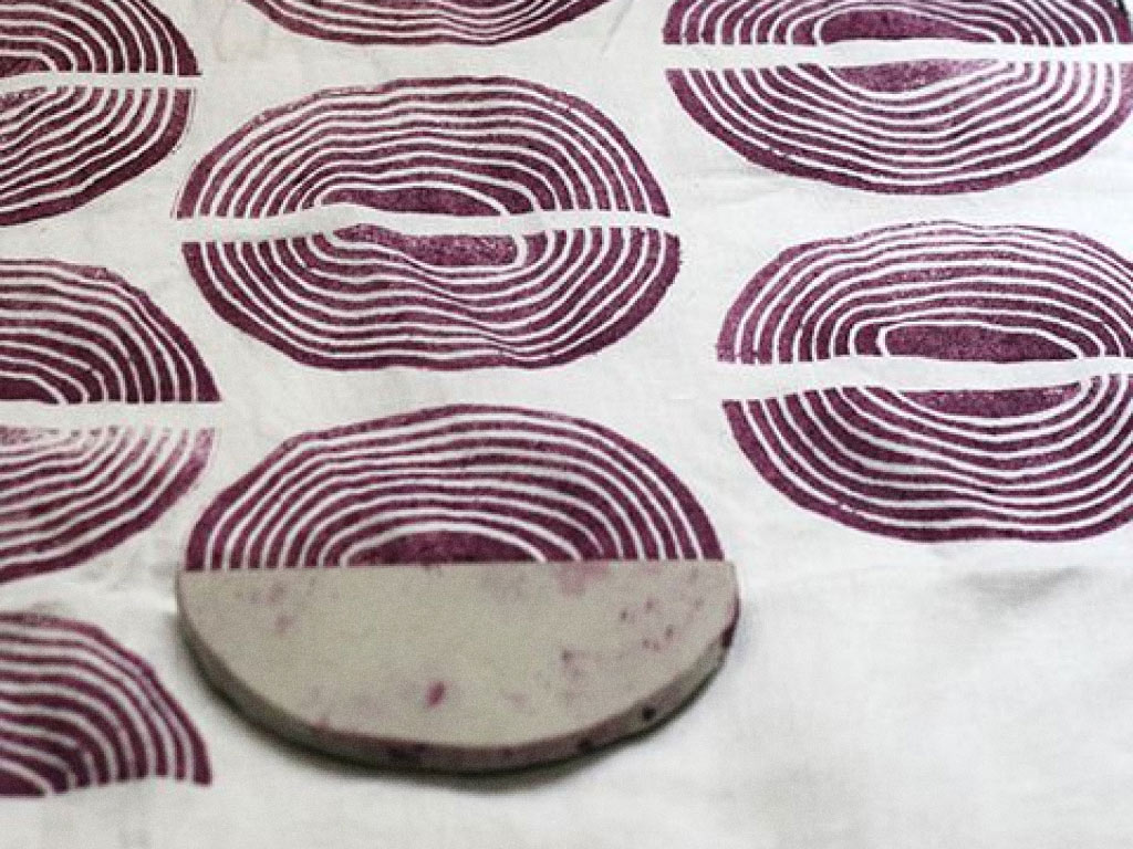 Slice of potato being used as a stamp for organic design elements