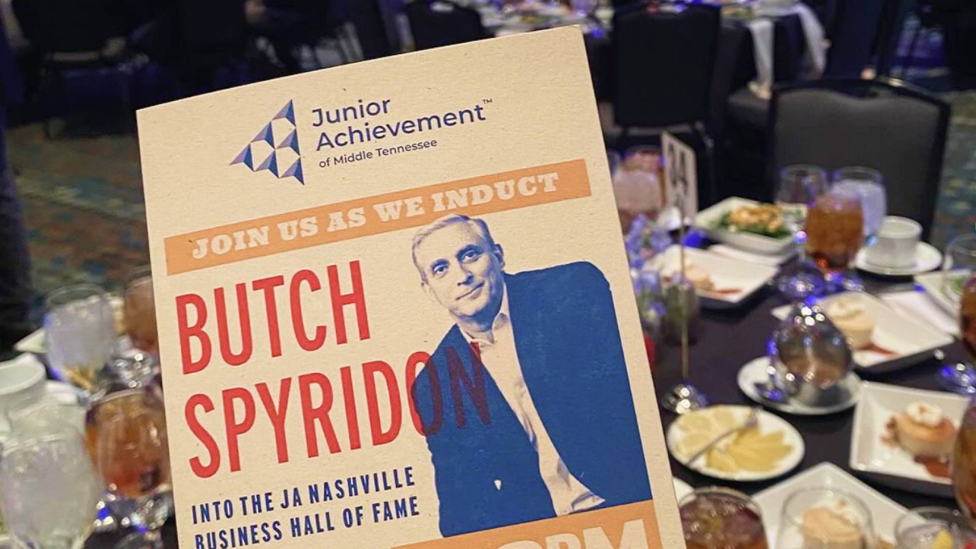 Photo of the Butch Spyridon brochure with table setting from the event in the background