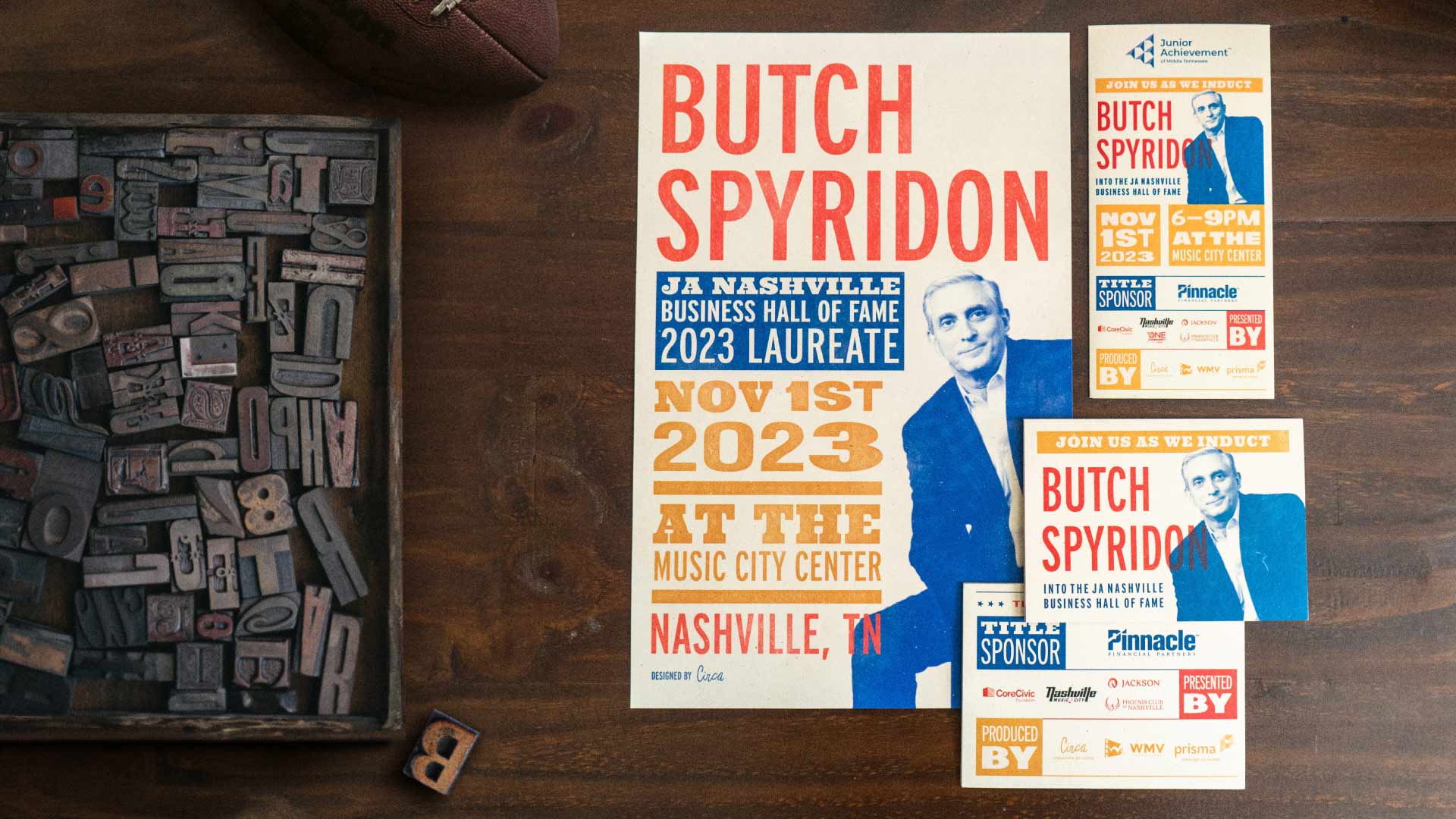 Butch Spyridon poster, invitation, and brochure suite on a dark wooden background with letterpress type next to it
