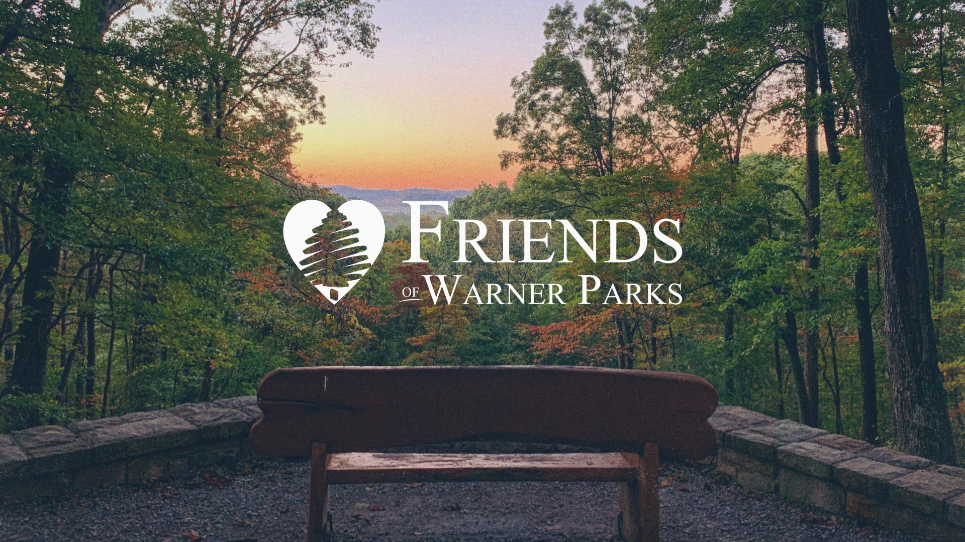 Park bench overlooking Warner Park with the Friends of Warner Parks logo overlaying the image.