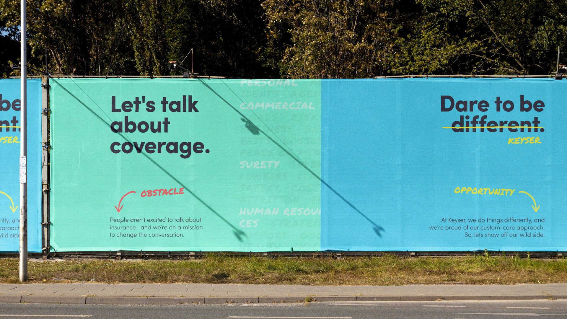 Fence wrap showing 2 different designs. The left wrap says "Lets talk about coverage." The right wrap says, "Dare to be different. Keyser." Different is crossed out and replaced with Keyser.